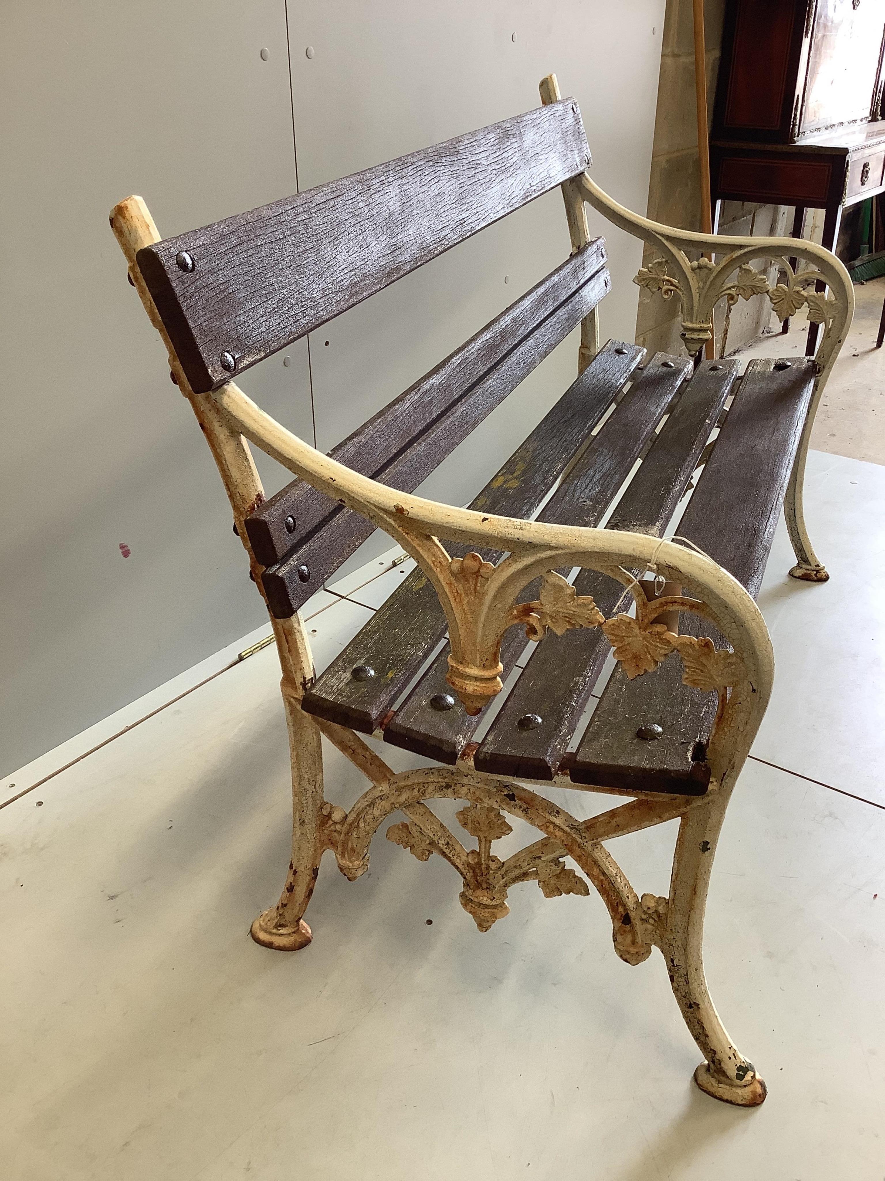 A Victorian style slatted cast iron garden bench, width 123cm, depth 58cm, height 86cm. Condition - fair